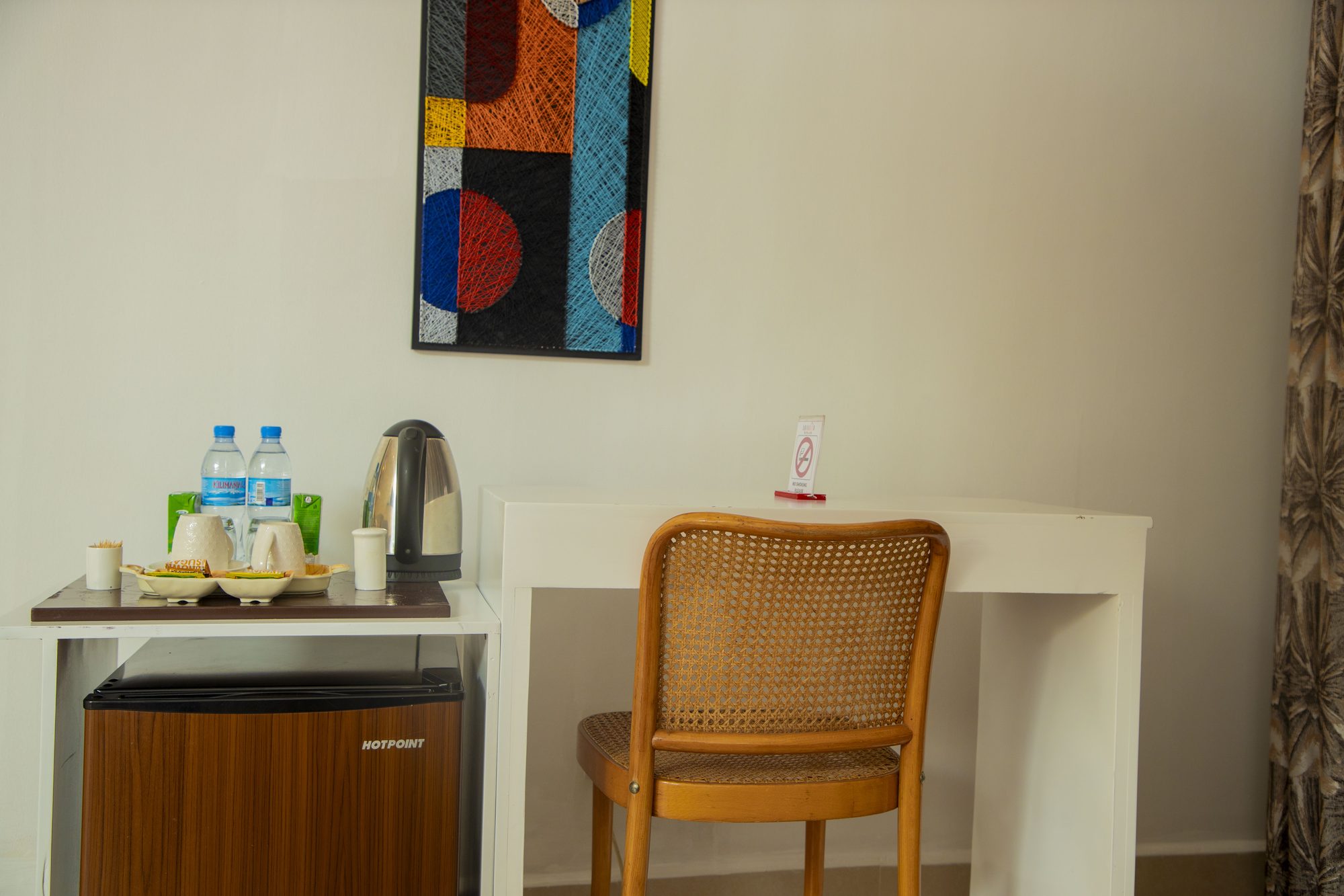 Tea and coffee tray, kettle, and mini-fridge in a Saivilla Hotel room